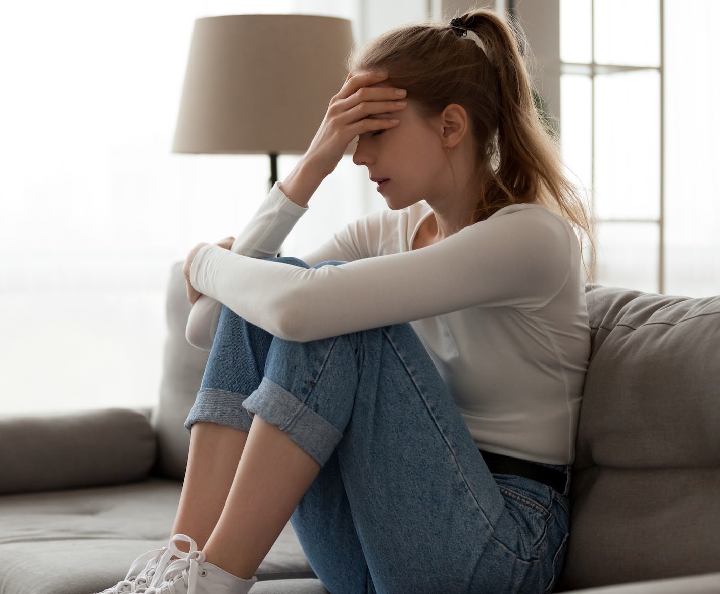 woman frustrated sitting on couch