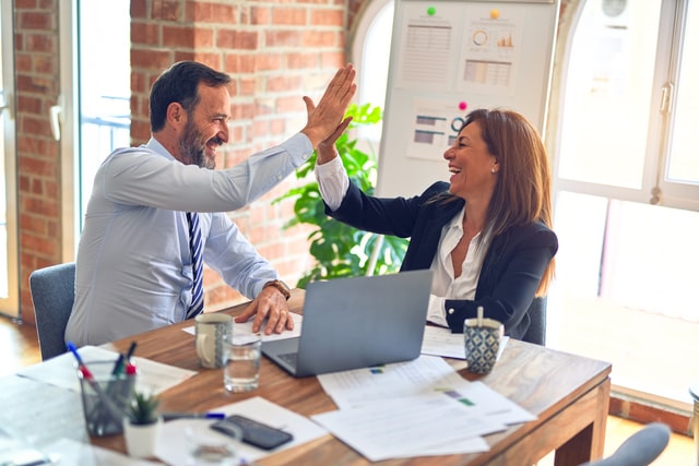 coworkers giving each other a high five