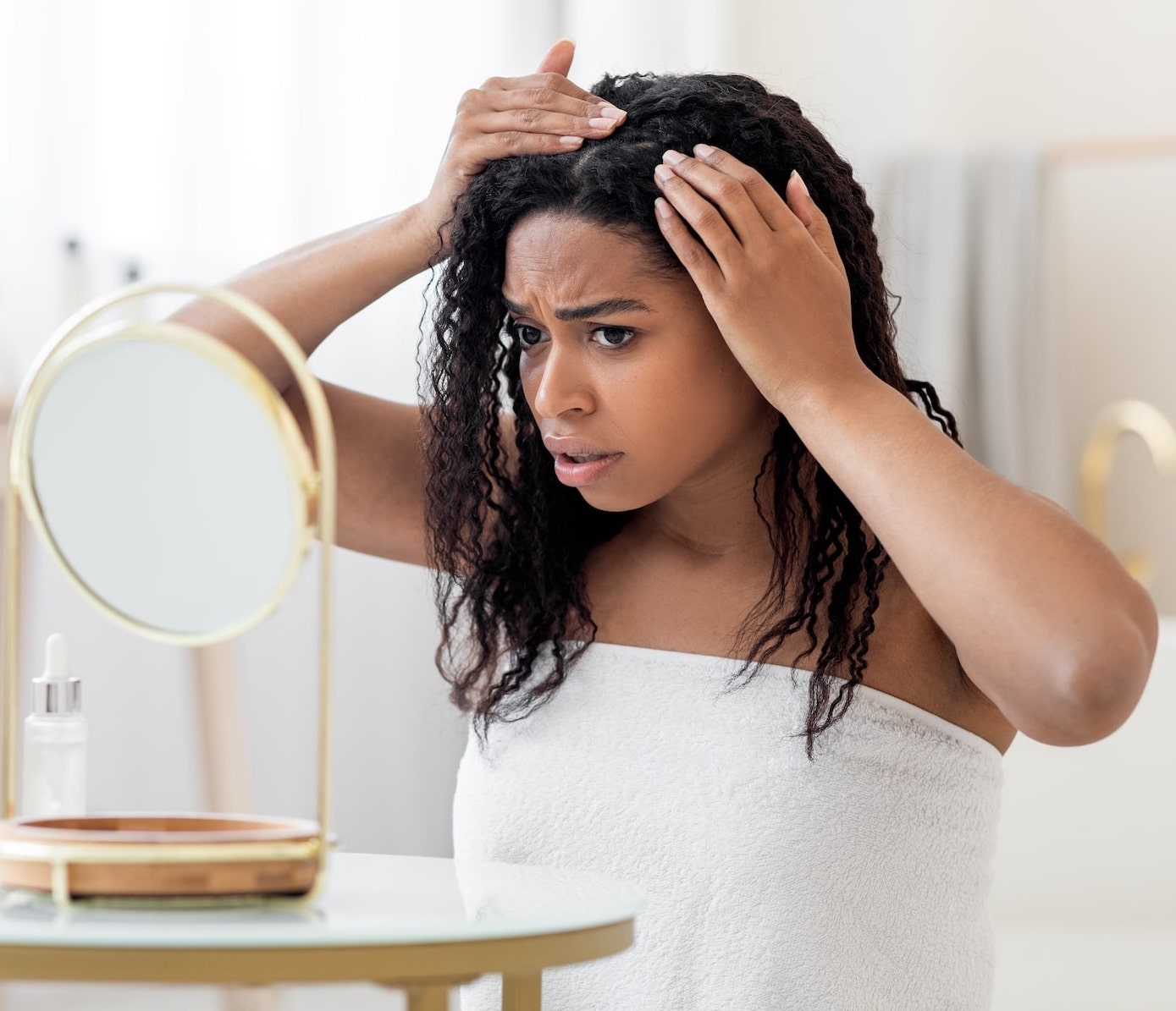 woman checking hair in mirror